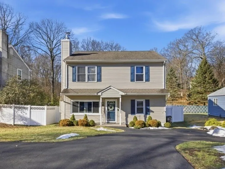 Two-story colonial with beige siding, navy shutters and a curved driveway at 12 Woodland Ave, Budd Lake, New Jersey